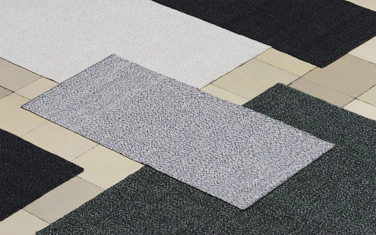 Normann Copenhagen Polli rugs made from 100% recycled post-consumer PET yarn with mottled patterns