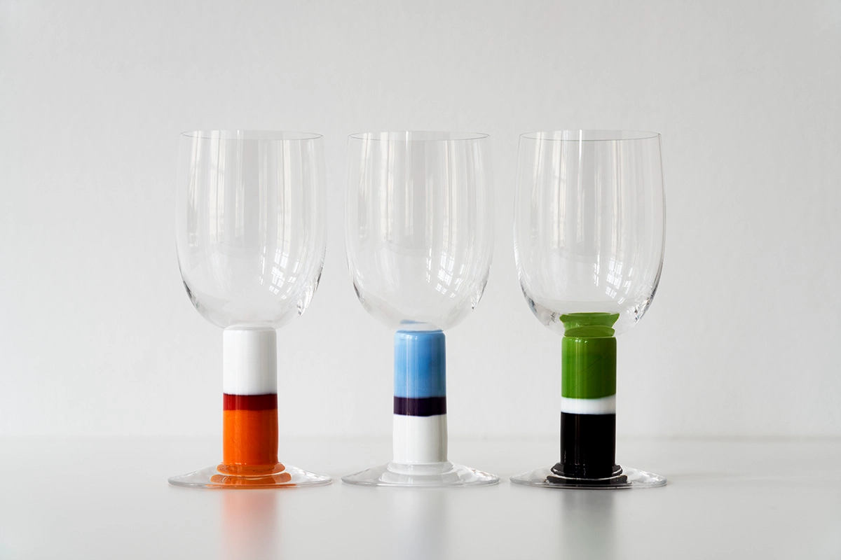 Gunnar Cyrén Popglas collection featuring handcrafted glass with colorful striped stems and clear bowls