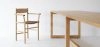 Akademia chair with armrests featuring curved seat and straight frame by Kaksikko for Nikari