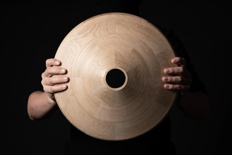 Detail of Pivå table base showing solid wood construction and tree trunk inspired pedestal design