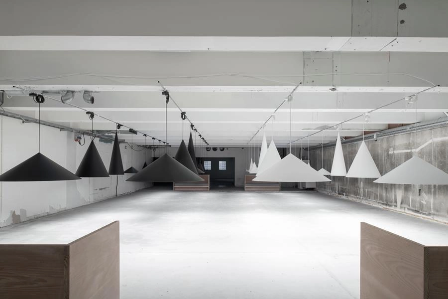 Complete W221 pendant installation showing multiple cone sizes and dramatic spatial lighting effects
