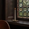 Holocene No. 6 brass candleholder by Ilse Crawford featuring concave disc design with central spike