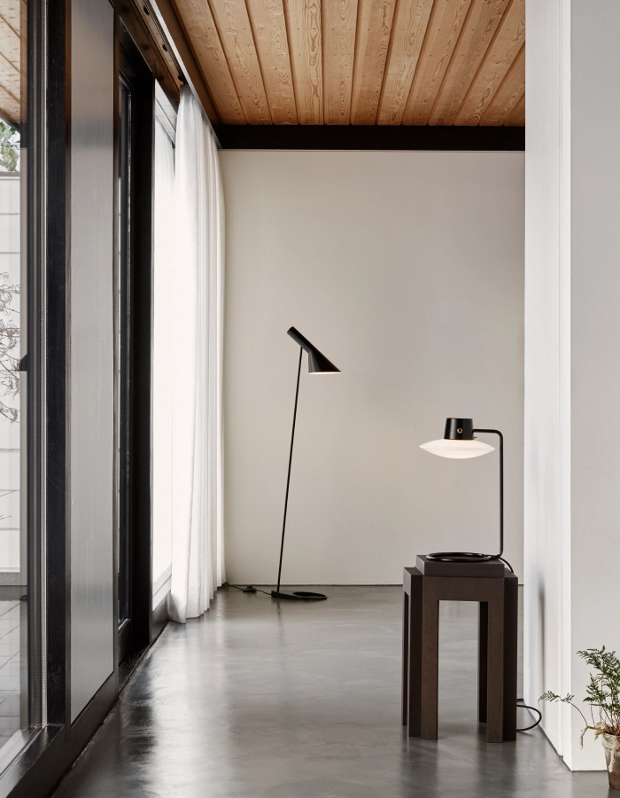 AJ Oxford table lamp by Arne Jacobsen featuring sleek stem and sculptural opal glass shade for Louis Poulsen