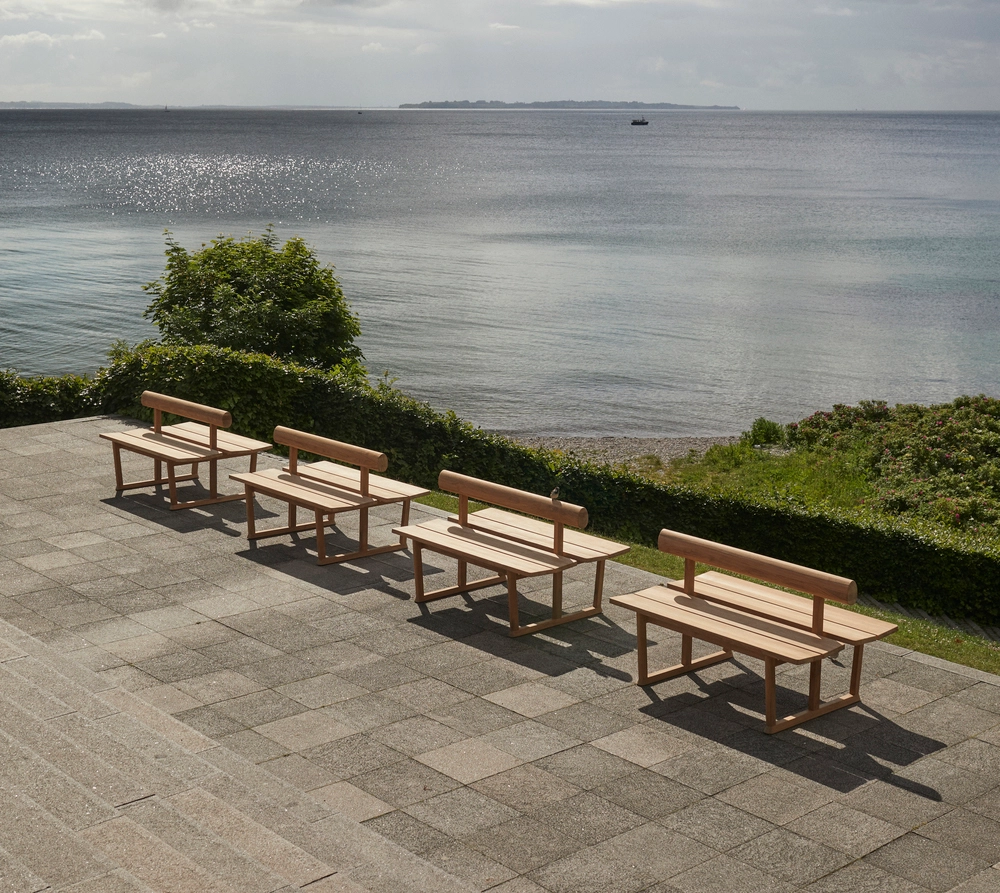 Banco bench by Hugo Passos for Skagerak featuring organic backrest and teak construction