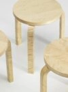 Stool 60 Loimu by Alvar Aalto for Artek featuring distinctive flame birch veneer and three-legged design