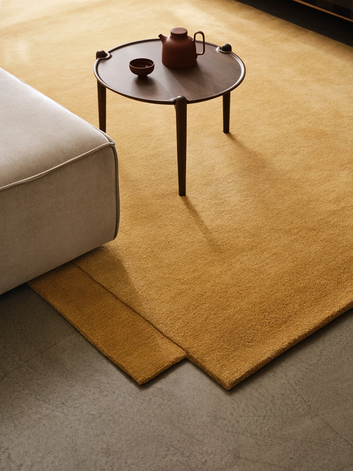 Lena Bergström's Level Rug displaying its signature trompe l'oeil effect with one layer appearing to rest on another.