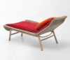 Paola Lenti Lazy Chair designed by Monica Förster featuring luxurious fur-like throw draped over a minimalist webbed frame