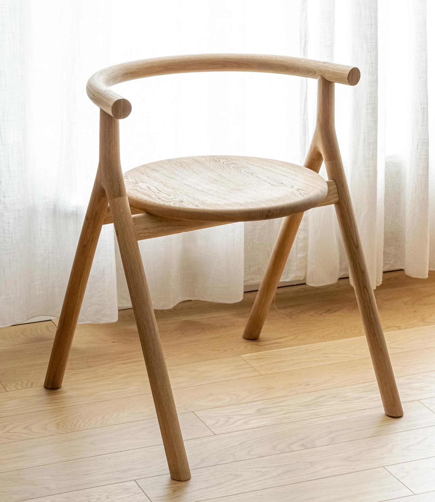 Kehikko chair by Studio Simo Lahtinen featuring minimalist wooden frame in oak and birch with clean lines and balanced proportions