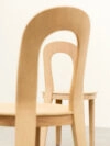 Close-up of Olivia Chair's form-pressed oak construction and ergonomic backrest opening design