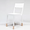 TS Chair by Thomas Sandell for Asplund featuring distinctive white finish with natural wood leg detail