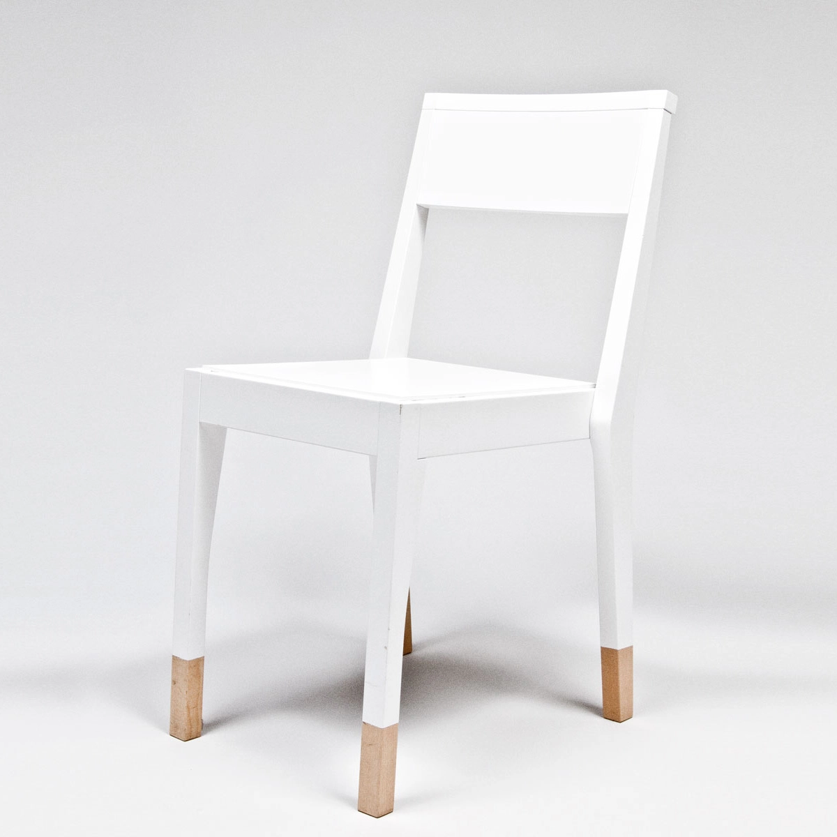 TS Chair by Thomas Sandell for Asplund featuring distinctive white finish with natural wood leg detail