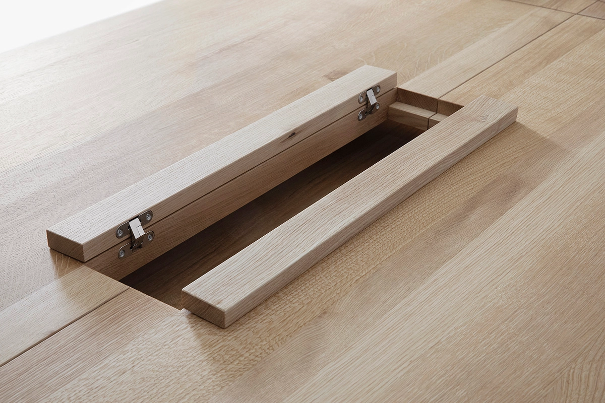 Detail of LINEA KVP11 table's innovative structure concealing presentation technology in birch finish
