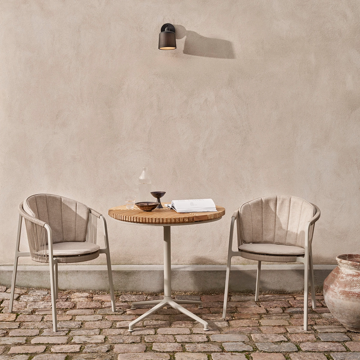 view of Vipp Lagrasse chairs showing the light, airy design and elegant cord detailing