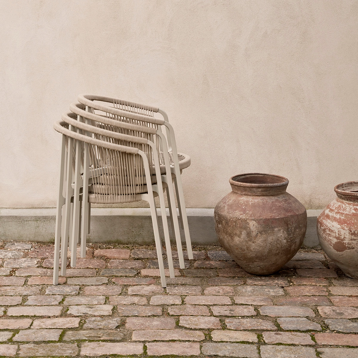 Vipp Lagrasse stackable outdoor chair with lightweight aluminum frame and woven cord detail, perfect for small patios