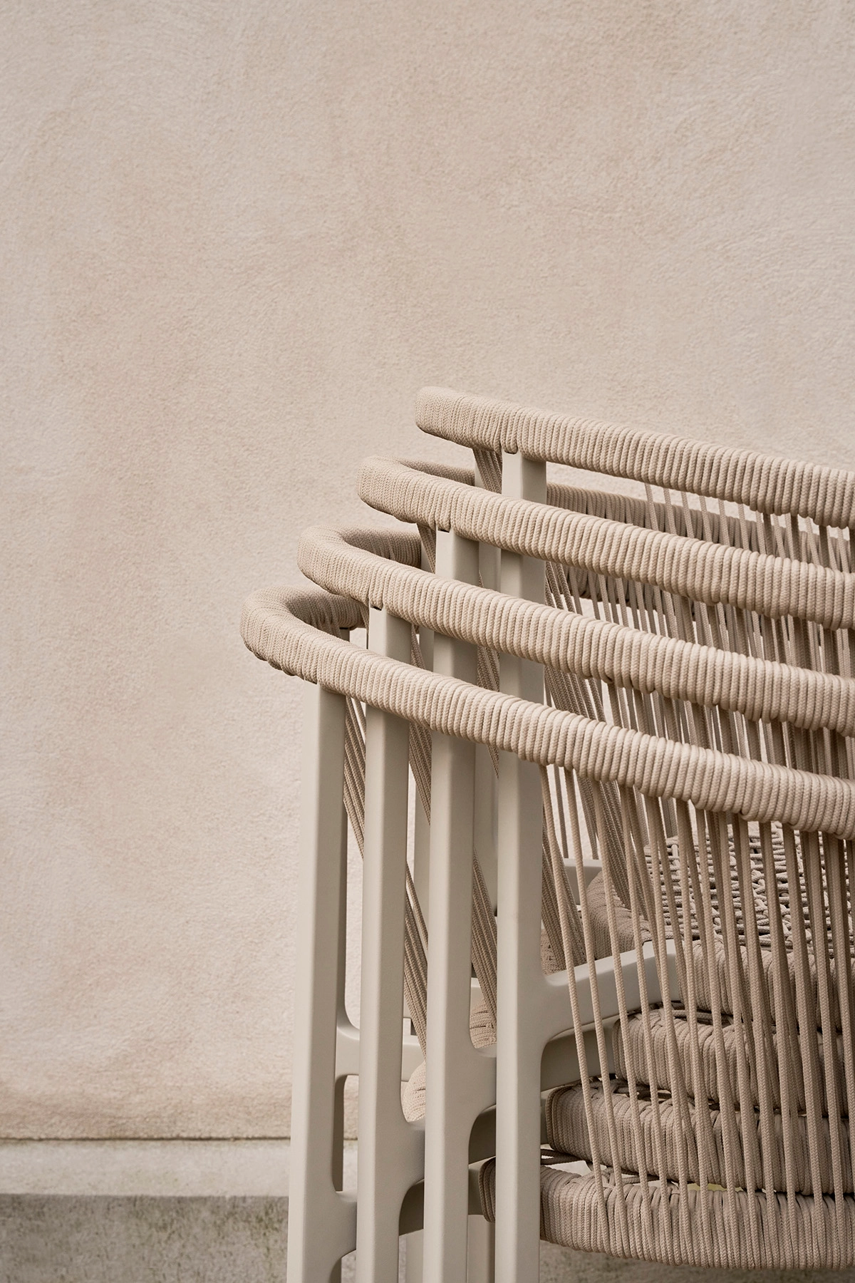 Close-up of Vipp Lagrasse chair showcasing the woven cord detail wrapping around the curved back and armrest frame