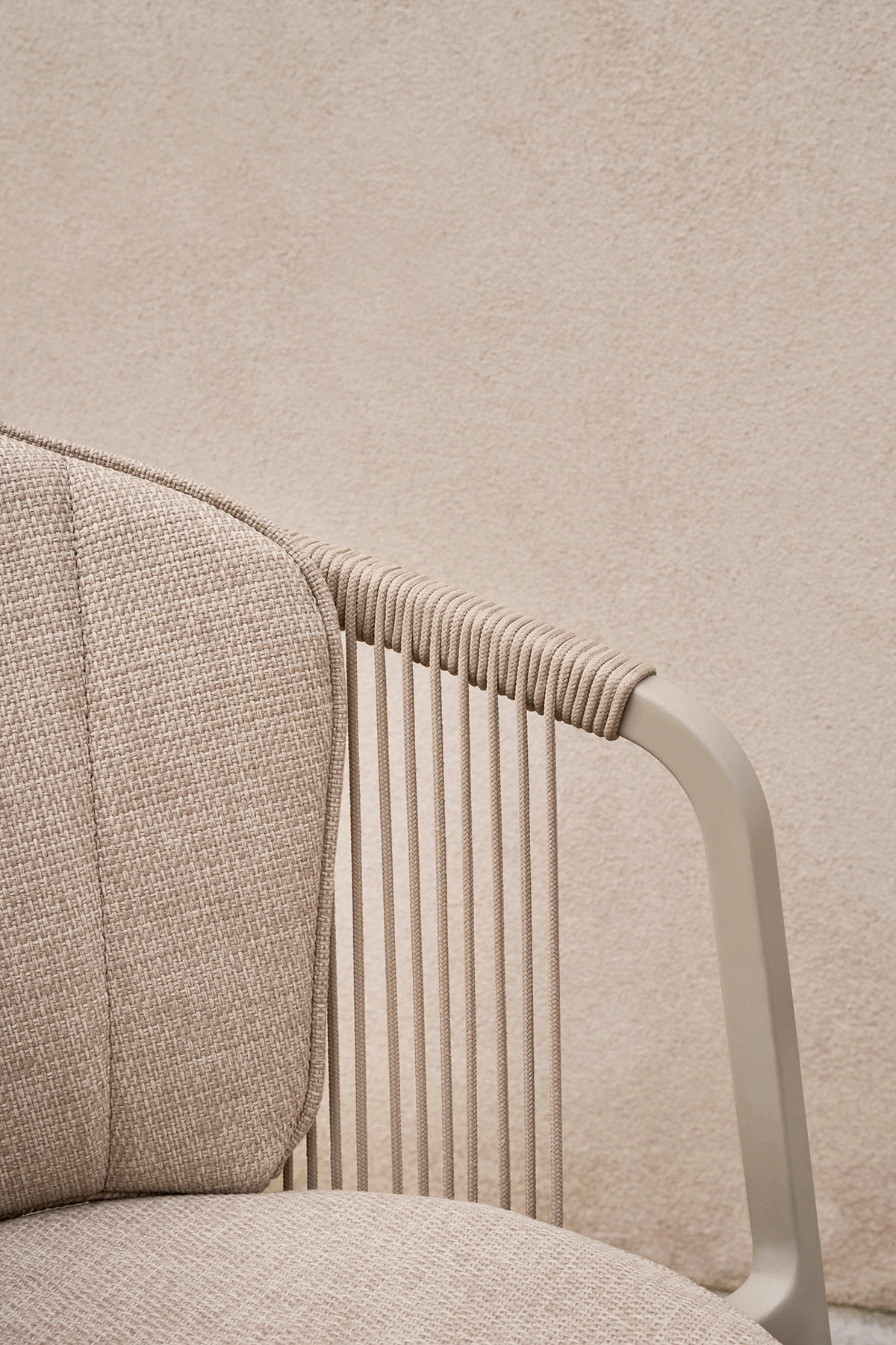 Vipp Lagrasse dining chair with curved backrest extending into armrests, designed for comfortable outdoor use