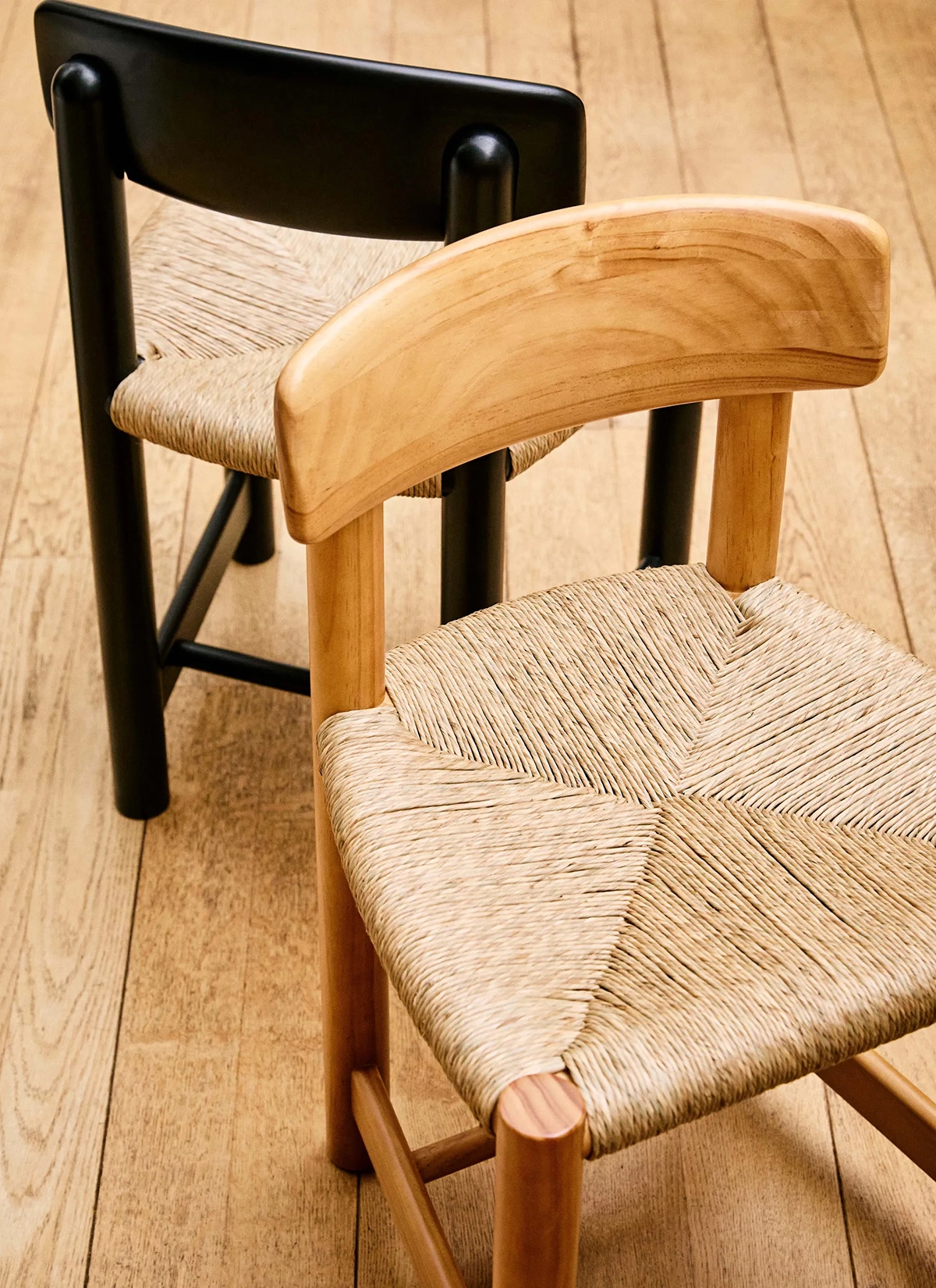 Close-up of Daumiller Side Chair's tilting backrest mechanism and handcrafted wooden joinery details by GUBI.