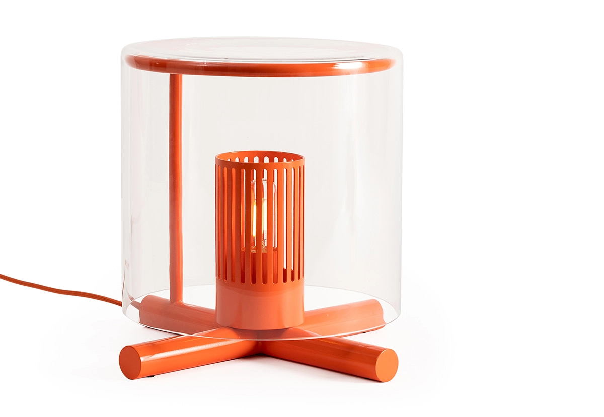 Close-up of Fireplace Lamp's mouth-blown glass cylinder with fine slits allowing light to create dancing patterns on surrounding surfaces.