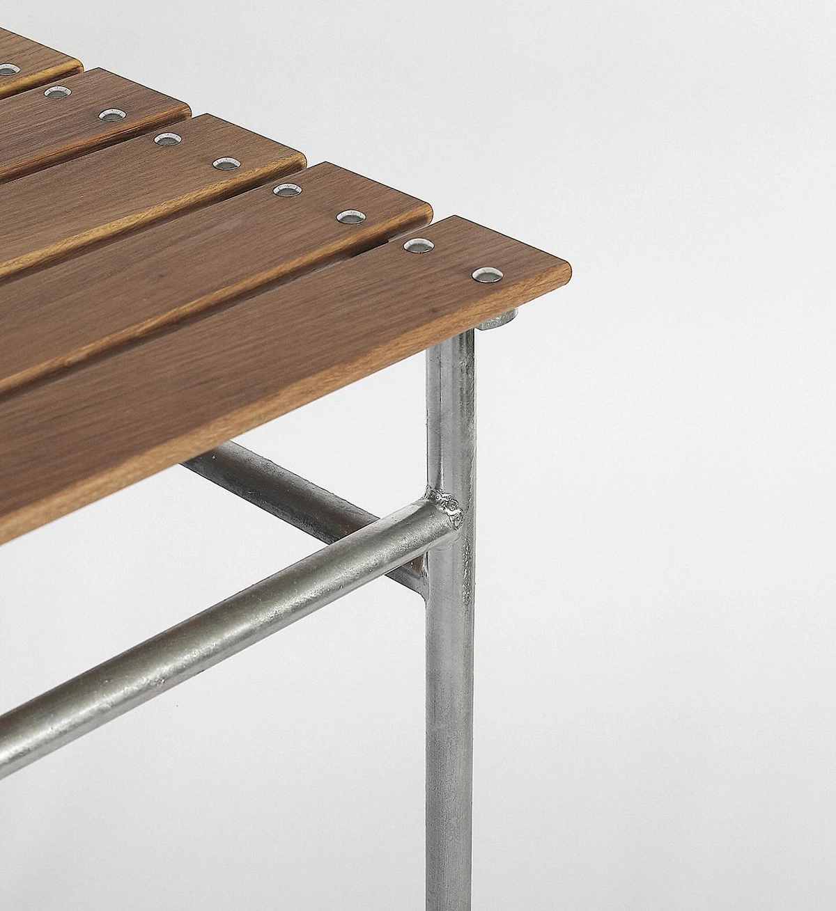 Stockholm Table outdoor dining furniture with riveted oak battens and galvanized steel construction