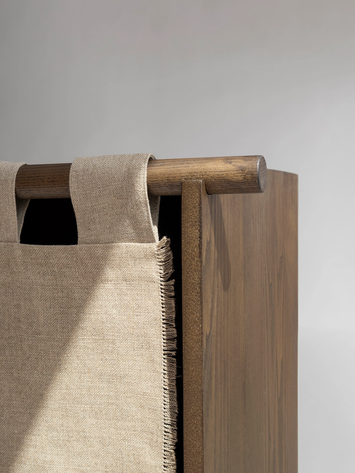 Close-up detail of the Veil Cabinet's natural linen door panel and elegant joinery, highlighting Origin Made's quality craftsmanship.
