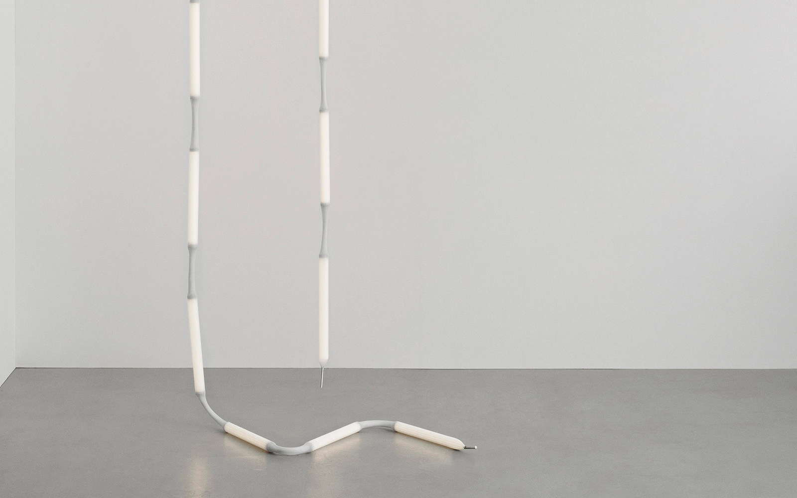 Reb Lamp by Verena Hennig for Normann Copenhagen displayed as a minimalist lighting installation with eight illuminated modules.