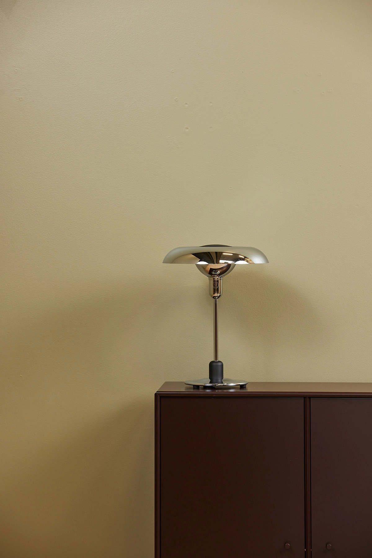 Piet Hein RA250 chrome lamp on designer desk creating focused work lighting with mathematical precision