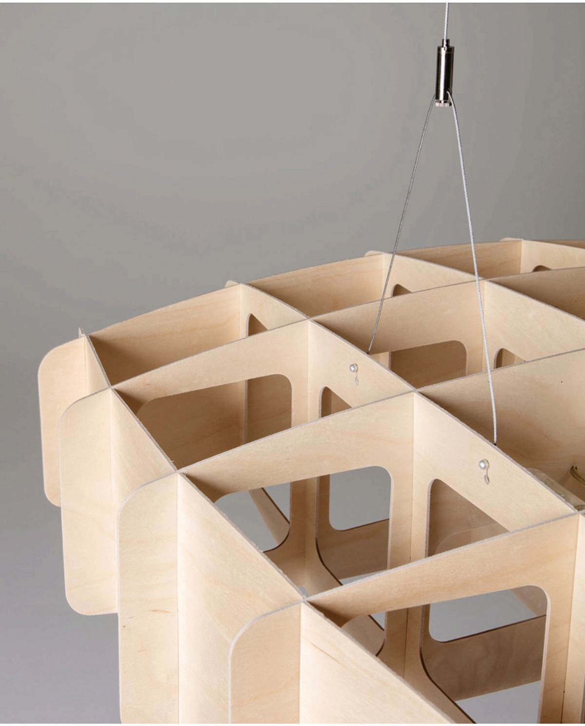 Close-up geometric lattice pattern of Ristikko birch plywood pendant showing Finnish craftsmanship detail